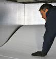 A contractor installing TerraBlock™ floor insulation in a Amherstburg crawl space