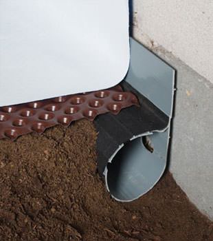 Closeup of a crawl space drainage system installed in Port Stanley