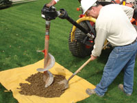 Auguring a hole in the earth for a foundation wall repair system in Amherstburg
