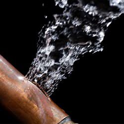 A bursting copper pipe in Chatham-Kent, with water gushing out.