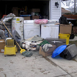 Soaked, wet personal items sitting in a driveway, including a washer and dryer in Leamington.