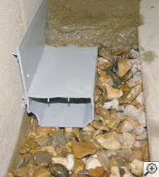 A no-clog basement french drain system installed in Essex