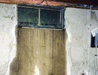 Water pouring out from a basement window in St Thomas